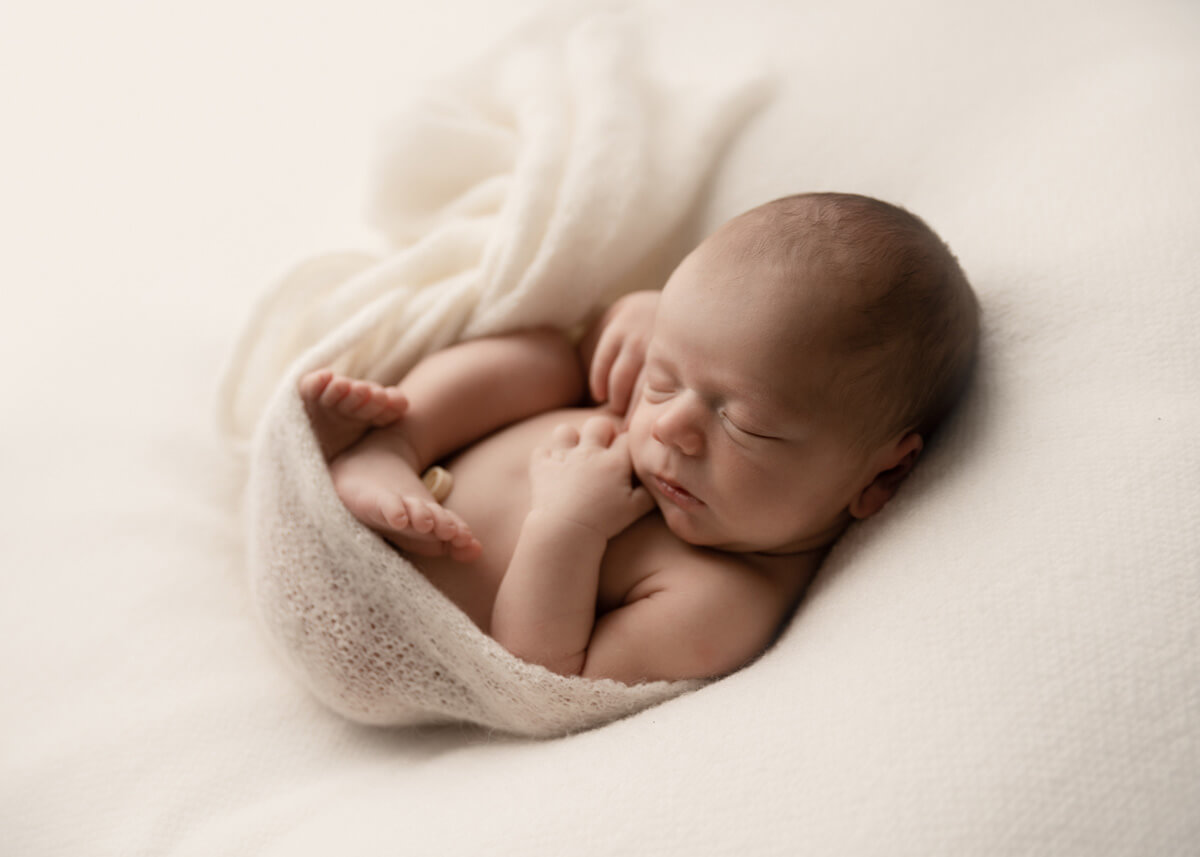 sleepy curly newborn pose from Adelaide newborn photo